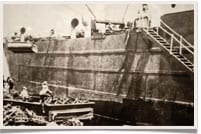 vintage men loading ship