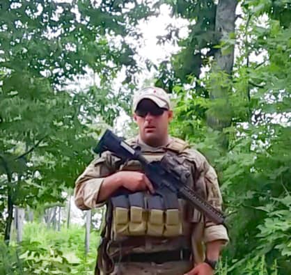 man in woods in military gear